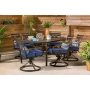 Hanover Montclair 7-Piece Steel Outdoor Dining Set with Navy Blue Cushions Swivel Rockers and Dining Table - Image 1